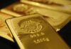 Gold inches lower as dollar gains ground